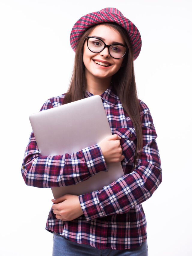 Young smiling confident woman using laptop computer and looking camera isolated over white background